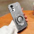 Glittery silver smartphone case with a circular ring attachment and multiple camera lenses.