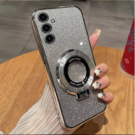 Glittery silver smartphone with three camera lenses and a circular attachment on the back.