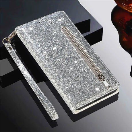 Glittery silver wallet-style phone case with a zipper pocket and wrist strap.