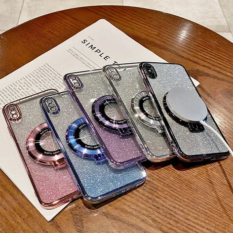 Glittery smartphone cases with circular pop-socket-like attachments in various colors.