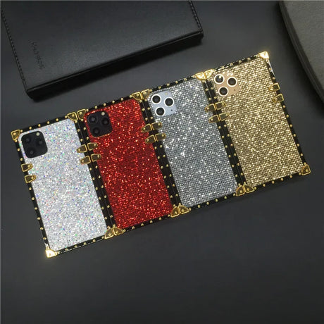 Glittery smartphone cases in white, red, silver, and gold colors with studded edges.