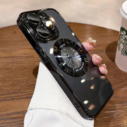 Glossy black iPhone case with a reflective, circular phone grip.