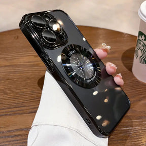 Glossy black iPhone case with a reflective, circular phone grip.