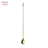 a gold spoon with a long handle