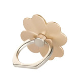 a gold flower ring with a white background