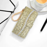 A gold glitter phone case with a cup of coffee and a pen