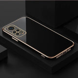 a gold iphone case on a black surface