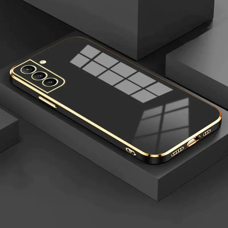 The gold iphone case is shown on a black surface