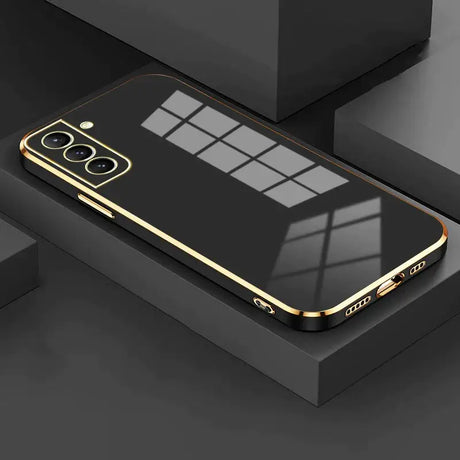 The gold iphone case is shown on a black surface