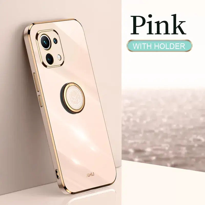 a gold iphone case with a circular ring