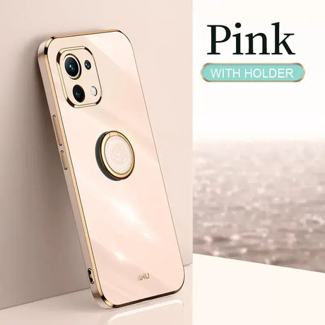 A gold iphone case with a circular ring