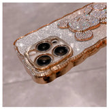 a gold iphone case with two black and white diamonds