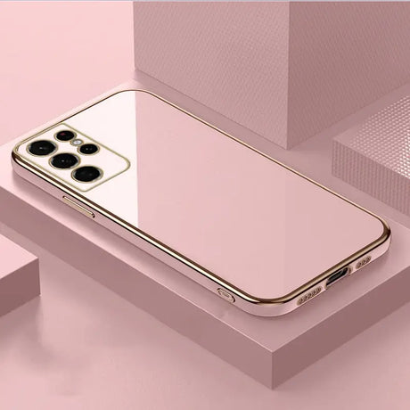 a gold iphone case on a pink background