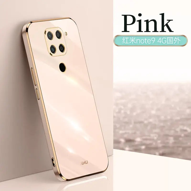 a gold iphone case sitting on top of a white table