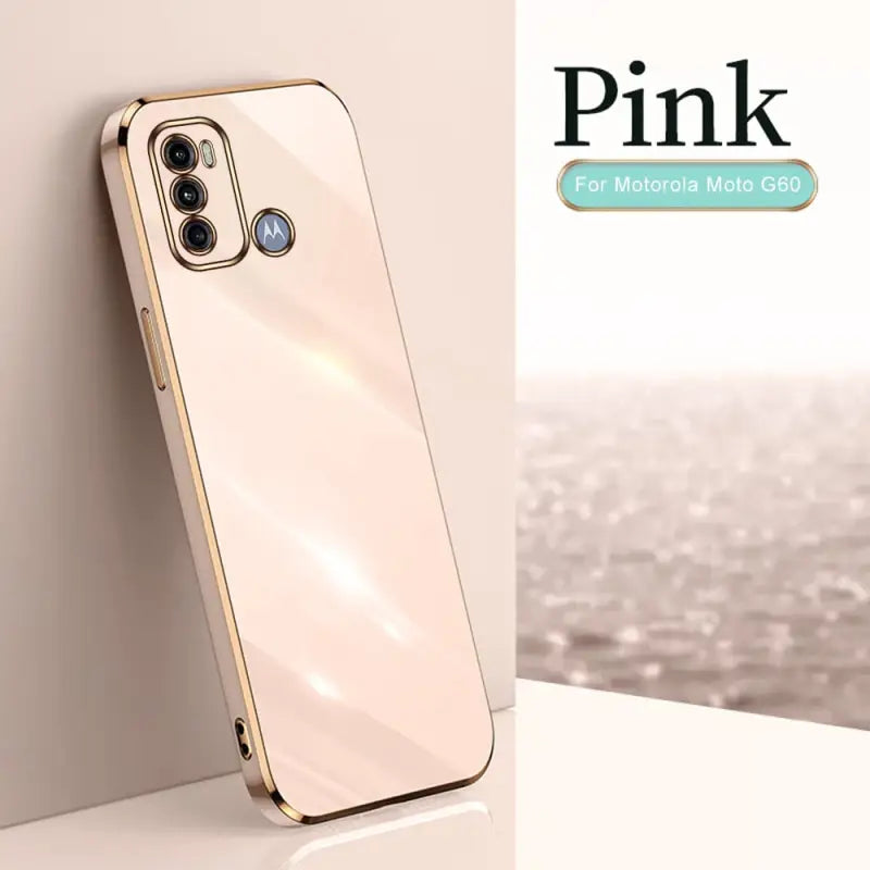 a gold iphone case sitting on a white table