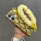 Gold quilted phone case with fluffy yellow handle.