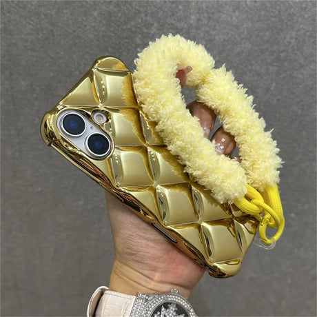 Gold quilted phone case with fluffy yellow handle.