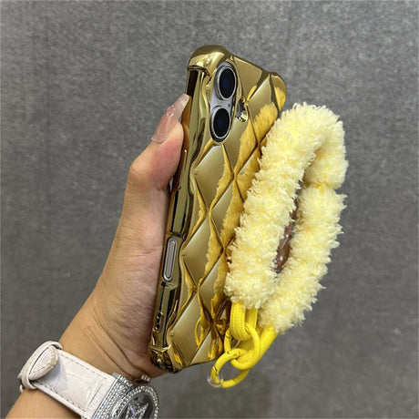 Gold quilted phone case with fuzzy yellow strap.