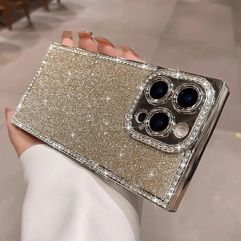 Glittering gold smartphone case with diamond-studded edges and camera lens frame.