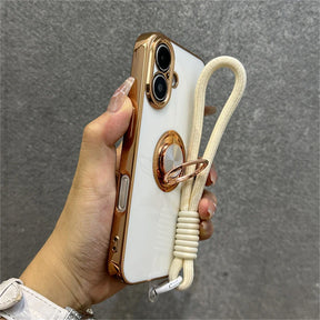 Gold-trimmed white phone case with ring stand and wrist strap.