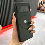 Google-branded portable battery pack or wireless charger held in a hand with decorated nails.