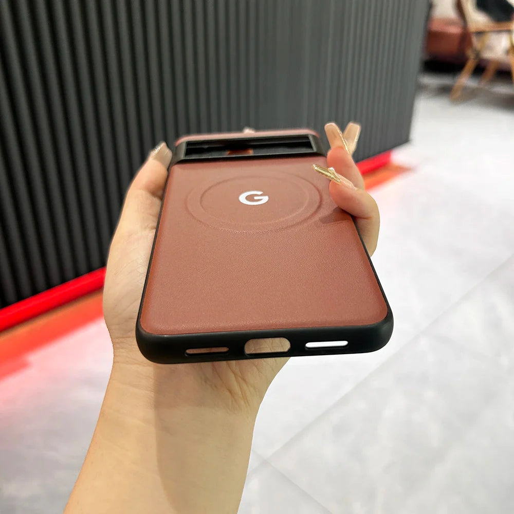 Google Pixel smartphone with a reddish-brown case being held in a hand.