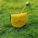a yellow golf putter on the grass