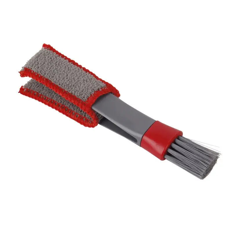 a red and gray brush with a black handle