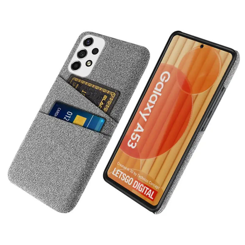 the back of a gray denim wallet case with a credit card slot