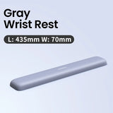 Gray elongated ergonomic wrist rest for keyboard use.