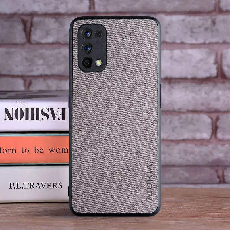 the back of a gray iphone case sitting on a stack of books