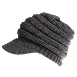 a gray knitted hat with a knot