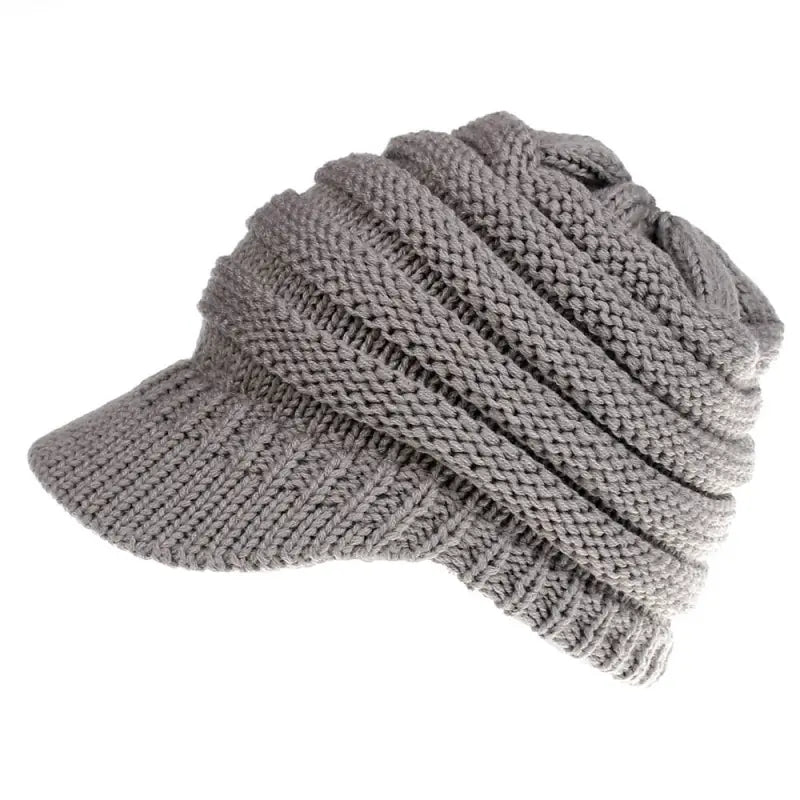 a gray knitted hat with a knot