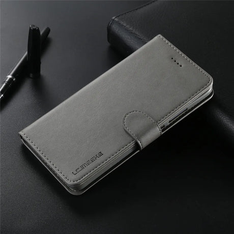 Gray leather wallet-style phone case with a closure flap.