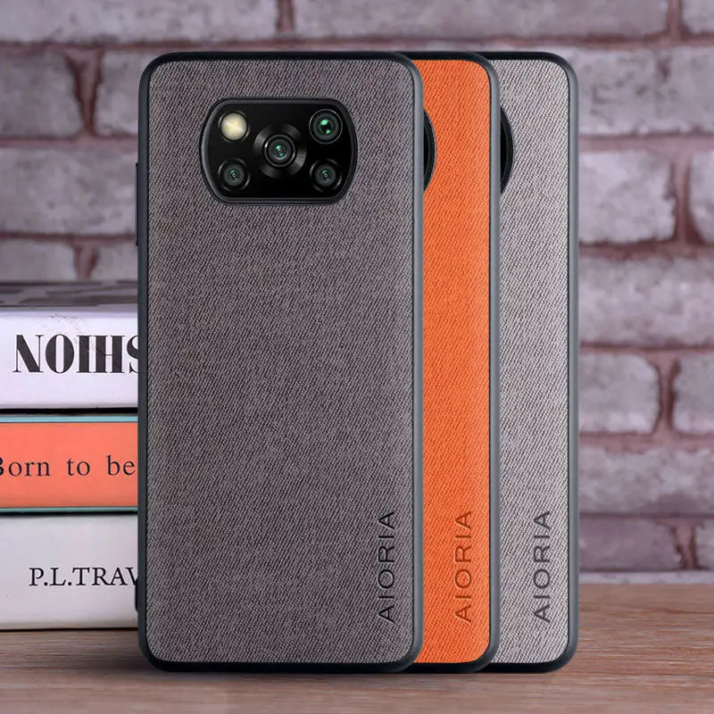 the back of a gray and orange case with a black leather cover
