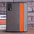 the back of a gray and orange iphone case with a black leather cover
