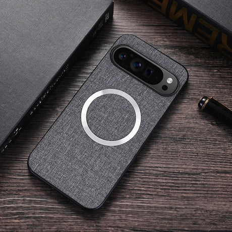 Gray smartphone case with a circular wireless charging indicator and a multi-lens camera cutout.