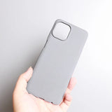 Gray smartphone case held in a hand.