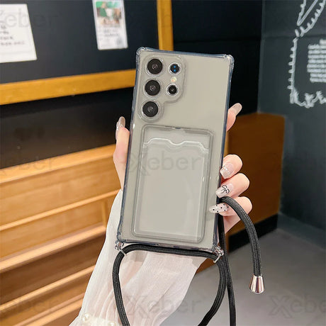 A gray smartphone in a clear case with an attached black lanyard and card holder.