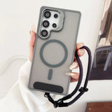 A gray translucent phone case with a visible magnetic ring and a black wrist strap.
