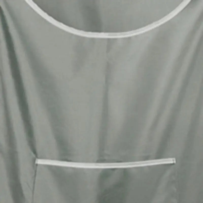 a grey shirt hanging on a wall