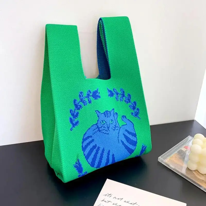 a green bag with a blue and green design