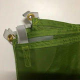 a green bag with two metal clips attached to it