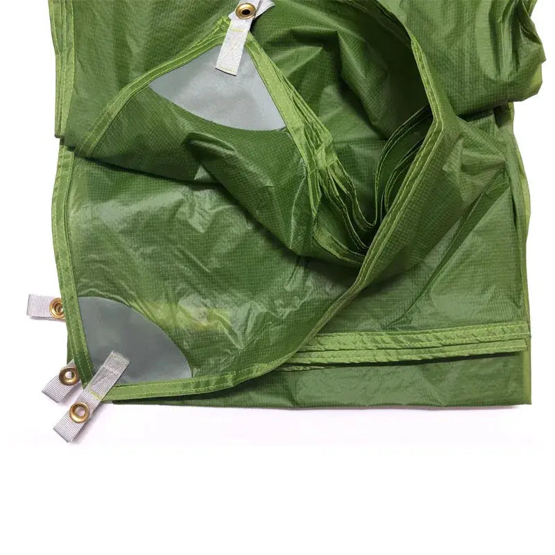 a green bag with a white tag on it
