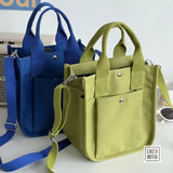 a green and blue bag with a blue strap