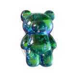 a green and blue teddy bear with a white background