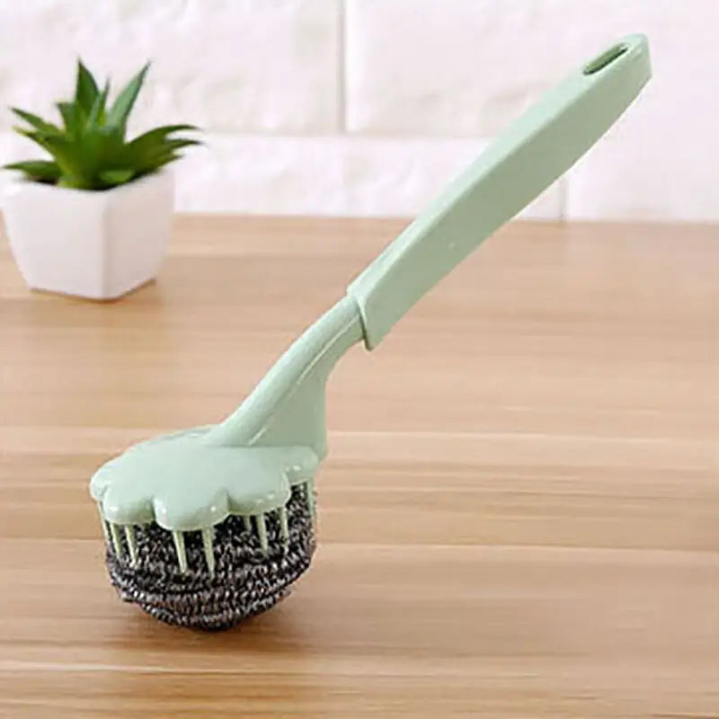 a green brush on a wooden table