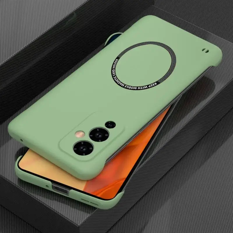 the back of a green case with a black circle on it