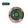 a green compass with gold trim and a rosette