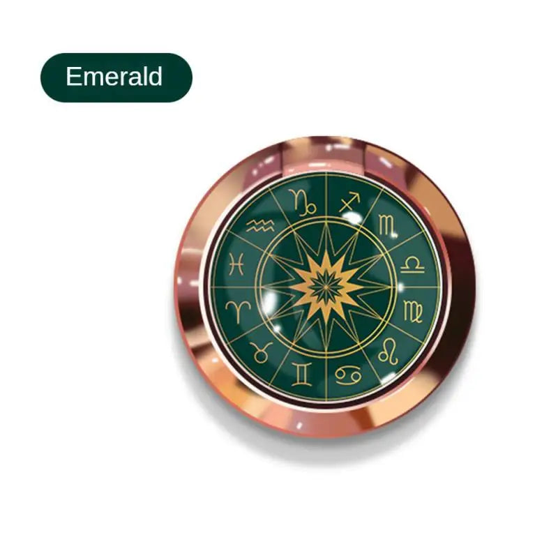 a green compass with gold trim and a rosette